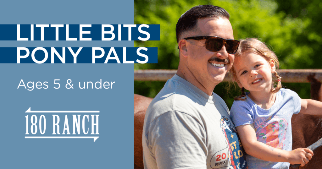 man with mustache and sunglasses holds daughter with purple shirt, brown hair and braids while smiling at the camera