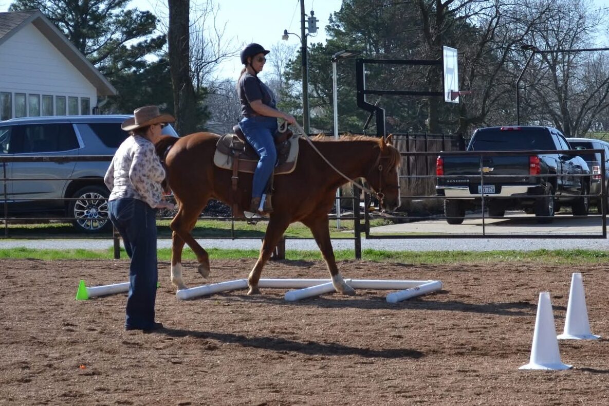Riding instructor teaching a student